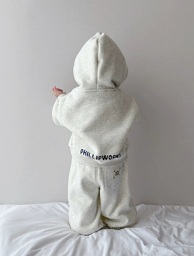 Person wearing a white hoodie with 'PHILIP WONG' branding on a plain background