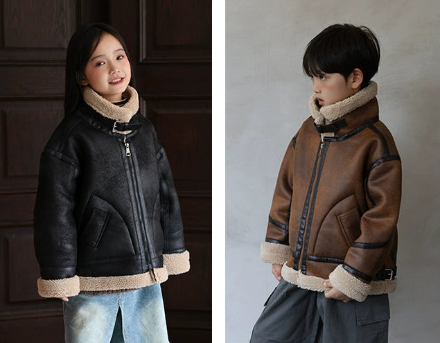 Two children wearing different jackets with fur-lined hoods against plain backgrounds.