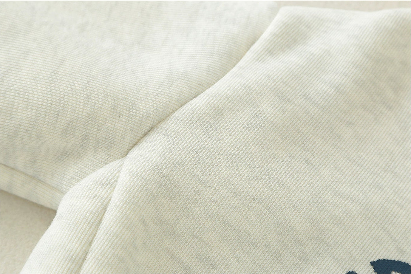 Close-up of beige fabric with text and icons indicating material properties.