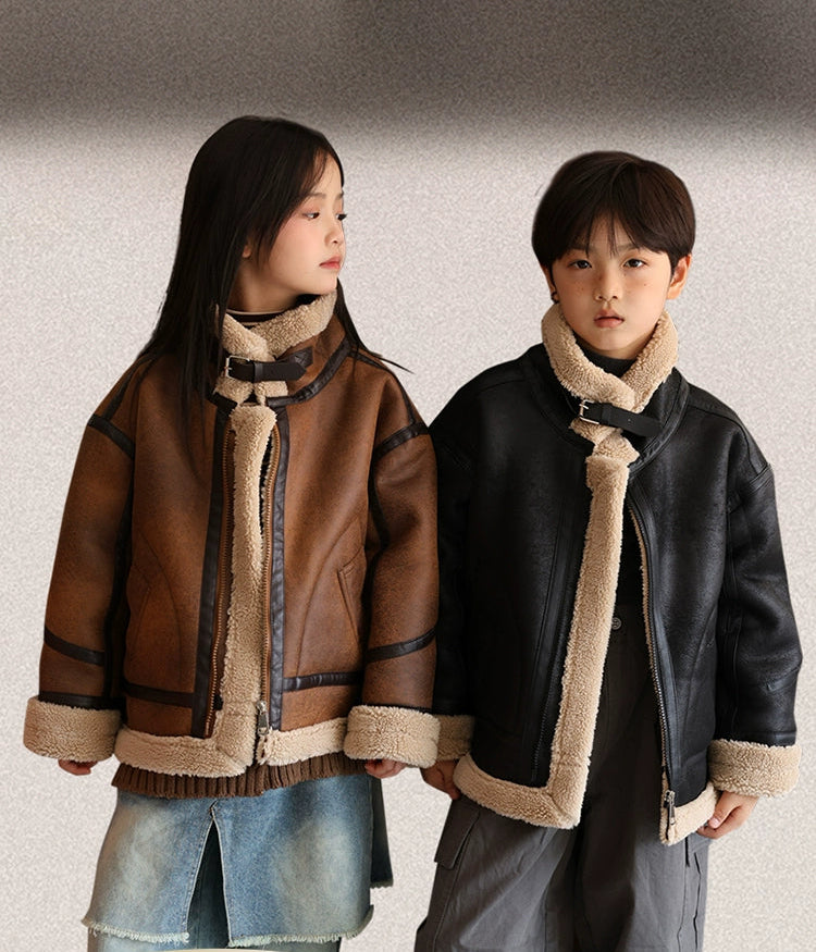 Two children wearing winter jackets with fur-lined hoods against a neutral background.