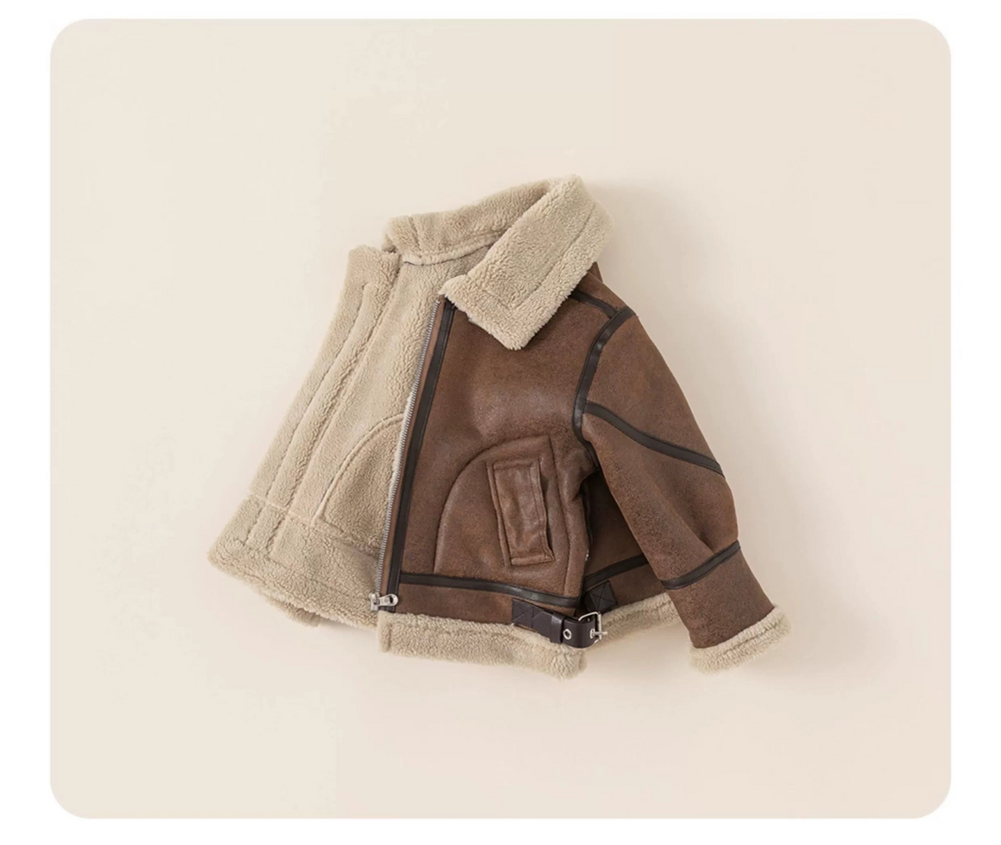 Brown leather jacket with beige fur lining on a light beige background