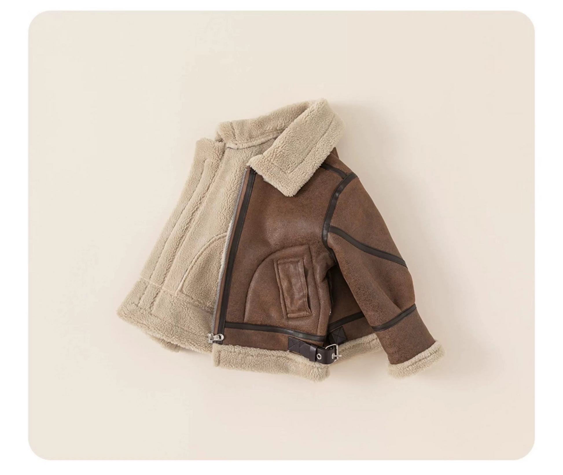 Brown leather jacket with beige fur lining on a light beige background