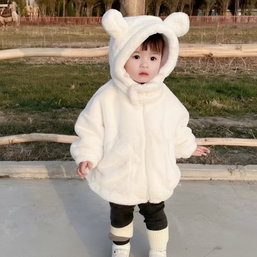 Child wearing a white fluffy hooded coat outdoors with promotional text overlay.