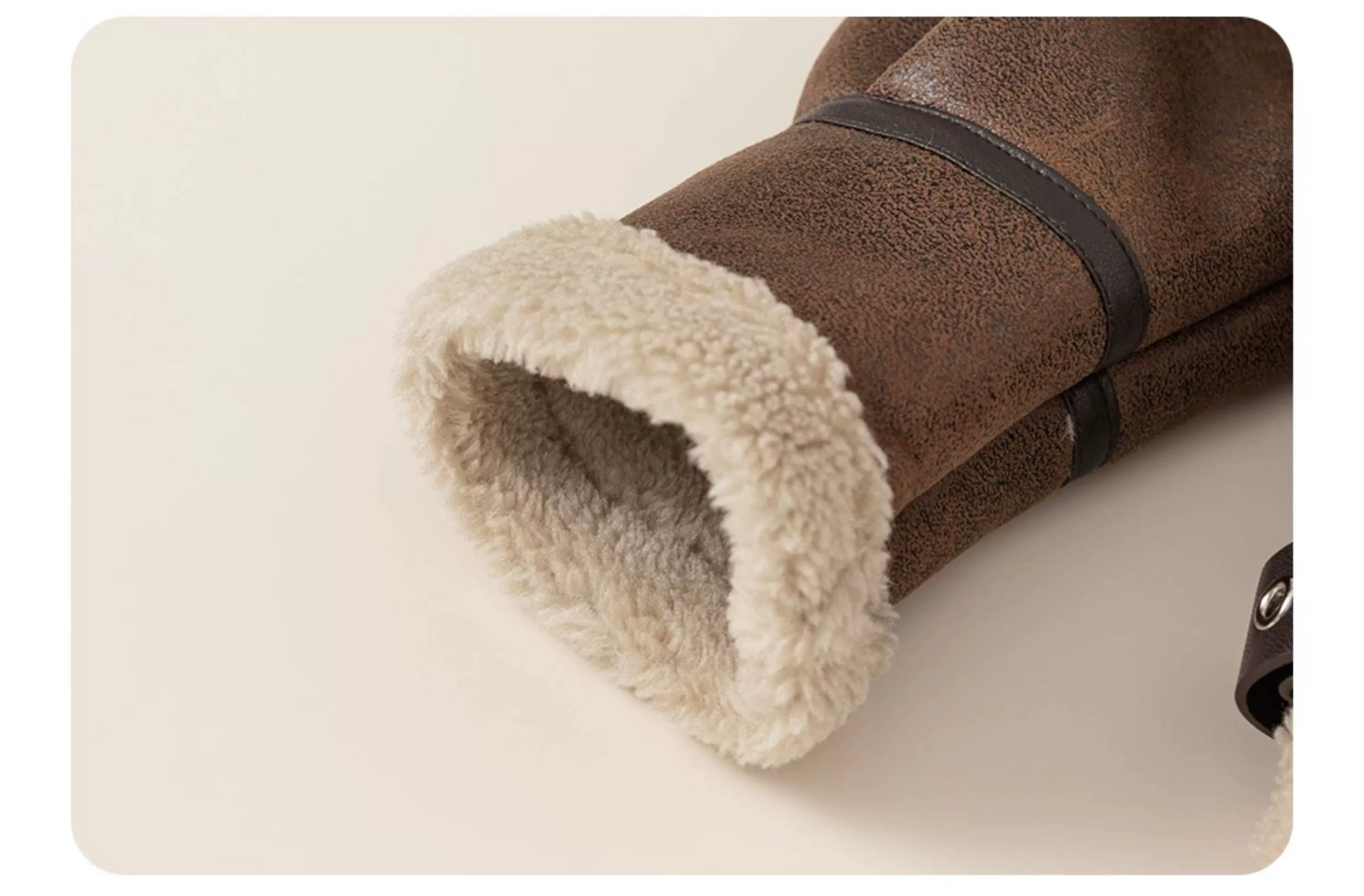 Close-up of a brown boot with white fur lining on a beige background