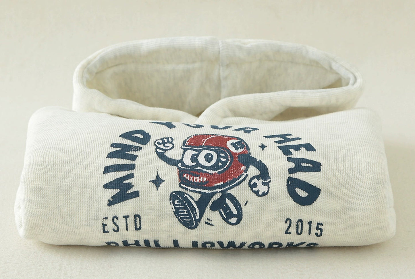 Neck warmer with branding on a beige background