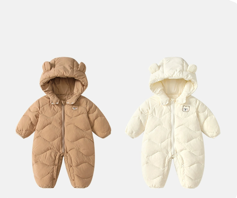 Two baby snowsuits, one brown and one white, on a light gray background
