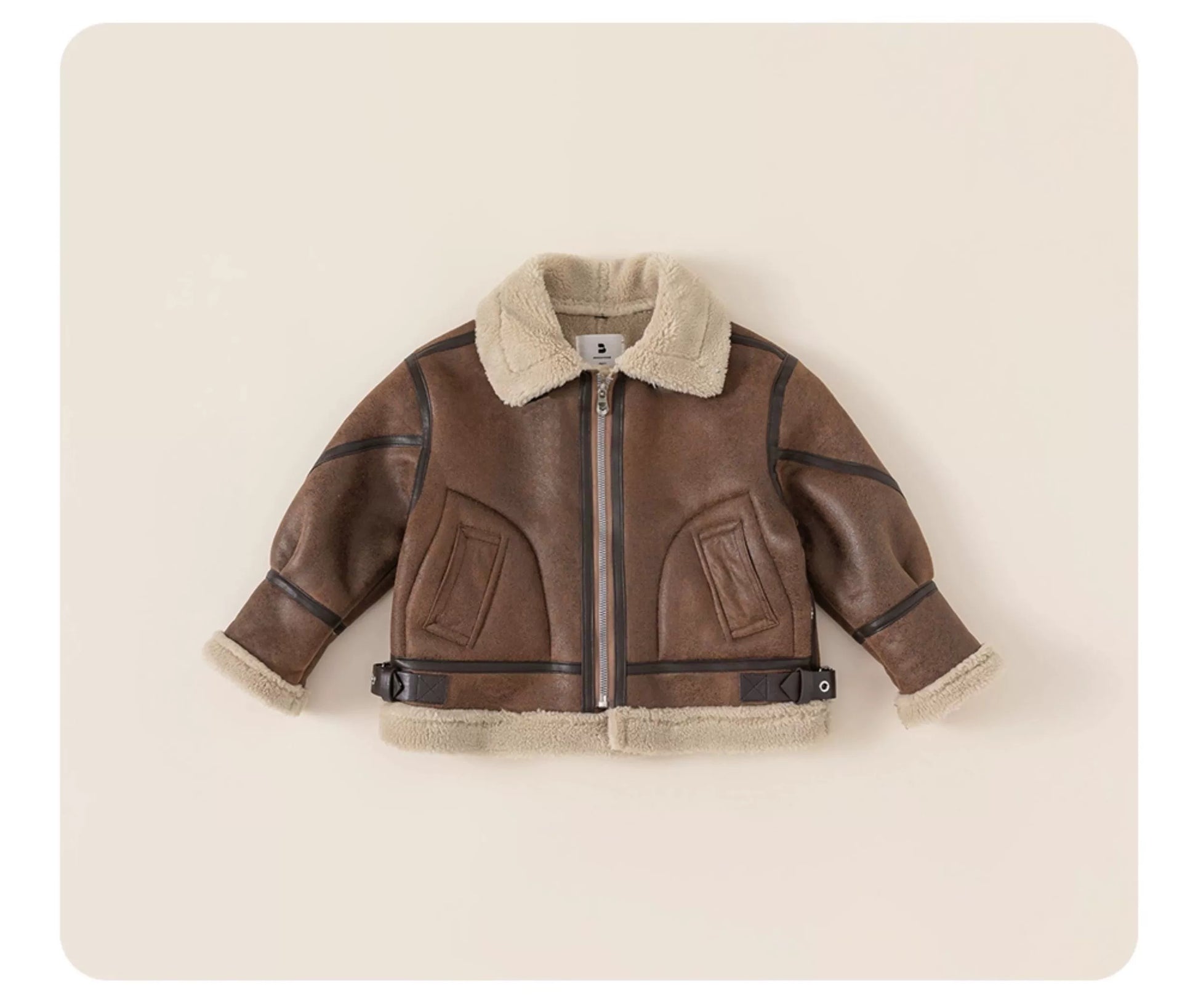 Brown children's jacket with fur collar on a beige background